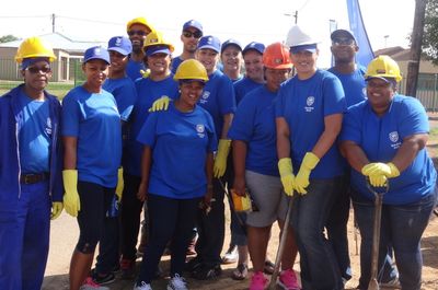 Our excited Bloemfontein CSI team on site to build houses